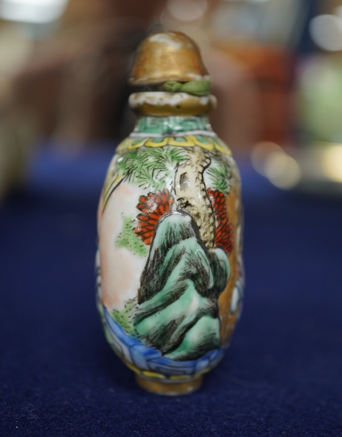 A Chinese enamelled and moulded porcelain erotic subject snuff bottle and stopper, Guangxu mark and possibly of the period, 6.5cm